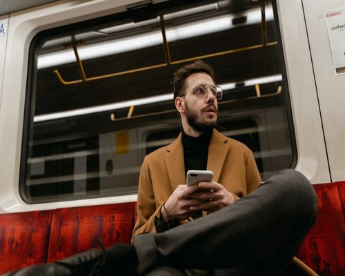 Commuter holding smartphone at a proper eye level to maintain good posture
