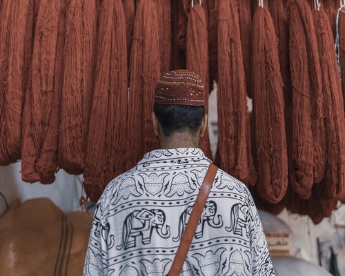 Local resident walking casually to a nearby traditional market