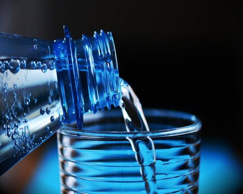 A fresh glass of clear mineral water on a desk